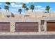 Street view of townhome garages with brown doors on a sunny day at 2667 Aracatuba Ave, Las Vegas, NV 89121