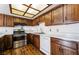 Well-lit kitchen showcasing wood cabinets, white appliances, and a functional layout at 2667 Aracatuba Ave, Las Vegas, NV 89121