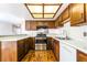Kitchen featuring stainless steel appliances, wood cabinets, and bright countertops at 2667 Aracatuba Ave, Las Vegas, NV 89121