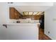 Kitchen with white countertop bar, wood cabinets, and modern appliances at 2667 Aracatuba Ave, Las Vegas, NV 89121