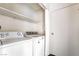 Laundry room equipped with a washer, dryer, and storage shelves for added convenience at 2667 Aracatuba Ave, Las Vegas, NV 89121