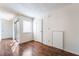 Bright living room featuring wood floors, white walls, and natural light from the sliding glass door at 2667 Aracatuba Ave, Las Vegas, NV 89121
