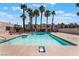 Community pool surrounded by palm trees offers a refreshing retreat at 2667 Aracatuba Ave, Las Vegas, NV 89121