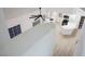 Modern white kitchen featuring an island with a white countertop, new appliances, and light wood flooring at 2925 Wigwam Pkwy # 923, Henderson, NV 89074