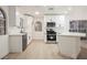 Well-lit kitchen featuring stainless appliances, white cabinetry, and a stylish breakfast bar area at 2925 Wigwam Pkwy # 923, Henderson, NV 89074