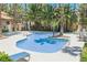 Community pool with lounge chairs and palm trees at 2925 Wigwam Pkwy # 923, Henderson, NV 89074