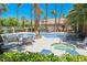 Resort-style pool and hot tub with lounge seating surrounded by lush landscaping and towering palm trees at 2925 Wigwam Pkwy # 923, Henderson, NV 89074