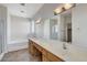 Bathroom featuring double sinks, tile flooring, and a large mirror at 3008 Hot Cider Ave, North Las Vegas, NV 89031