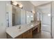 Bathroom featuring double sinks, tile flooring, a large mirror, and open access to a bedroom at 3008 Hot Cider Ave, North Las Vegas, NV 89031