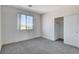 Bright bedroom featuring a closet, a window offering a view, and neutral gray carpet flooring at 3008 Hot Cider Ave, North Las Vegas, NV 89031