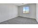 Bright bedroom with neutral carpeting and a view of the mountains at 3008 Hot Cider Ave, North Las Vegas, NV 89031