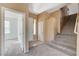 Open entryway features neutral carpet, stairs to the second floor, and tile flooring at 3008 Hot Cider Ave, North Las Vegas, NV 89031