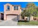 Inviting two-story home features a two car garage, mature landscaping, and classic architecture at 3008 Hot Cider Ave, North Las Vegas, NV 89031