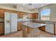 A kitchen featuring granite countertops and a center island with wood-look laminate flooring at 3008 Hot Cider Ave, North Las Vegas, NV 89031