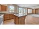 Kitchen featuring a center island, granite countertops, and wood-look laminate flooring at 3008 Hot Cider Ave, North Las Vegas, NV 89031