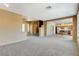Open-concept living area with carpet, neutral walls, and views into the kitchen and stairway at 3008 Hot Cider Ave, North Las Vegas, NV 89031