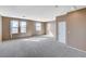 Large living room with neutral walls, carpet, and natural lighting streaming through multiple windows at 3008 Hot Cider Ave, North Las Vegas, NV 89031