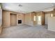 Expansive living room featuring gray carpet, neutral walls, and a classic fireplace at 3008 Hot Cider Ave, North Las Vegas, NV 89031