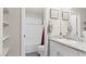 Bathroom with white tiled shower-tub combo, granite countertop, and floating shelves at 333 Canary Song Dr, Henderson, NV 89011