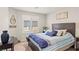 Bedroom featuring a neutral color palette, shuttered windows, and a dark wood headboard at 333 Canary Song Dr, Henderson, NV 89011