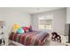 Bedroom with neutral walls, shuttered windows, decorative pillows, and soft plush carpet at 333 Canary Song Dr, Henderson, NV 89011