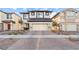 Two story home featuring a two car garage with a patterned driveway and minimalistic landscaping at 333 Canary Song Dr, Henderson, NV 89011