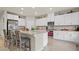 Bright kitchen featuring white cabinets, stainless steel appliances, and a stone island with barstool seating at 333 Canary Song Dr, Henderson, NV 89011
