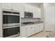 Modern kitchen featuring stainless steel appliances and sleek white cabinets at 354 Spotted Dove St, Las Vegas, NV 89138