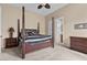 Spacious bedroom with four-poster bed, carpet flooring, and ensuite bathroom entrance at 37 Avenida Fiori, Henderson, NV 89011