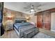 Beautiful main bedroom showcasing modern ceiling fan, barn door closet, new hardwood flooring, and neutral paint at 3960 Badgerbrook St, Las Vegas, NV 89129