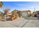 View of the house with a one-car garage and front yard at 4432 Ash Ave, Las Vegas, NV 89110