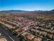 Wide aerial shot showcasing the community layout, nearby amenities, and stunning mountain backdrop at 4434 Verdiccio Ave, Las Vegas, NV 89141