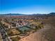 Enjoy community amenities, with this aerial view showcasing a neighborhood with a park, and mountain views at 4434 Verdiccio Ave, Las Vegas, NV 89141