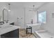 Modern bathroom featuring a soaking tub, step-in shower, and sleek dual sink vanity at 4434 Verdiccio Ave, Las Vegas, NV 89141