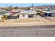 Charming single story home with gravel yard, covered porch, and convenient driveway access at 457 Federal St, Henderson, NV 89015