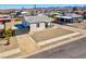 Charming single story home with gravel yard, covered porch, and convenient driveway access at 457 Federal St, Henderson, NV 89015