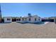Spacious gravel backyard with white house, shed and covered patio, perfect for outdoor activities at 457 Federal St, Henderson, NV 89015