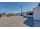 Large gravel backyard featuring shed, covered patio, and ample space for various outdoor activities at 457 Federal St, Henderson, NV 89015