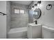 Bathroom features modern vanity and lighting fixtures, as well as tiled shower and tub at 457 Federal St, Henderson, NV 89015