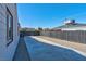 Long concrete driveway between the house and fence, offering parking and access to the backyard at 457 Federal St, Henderson, NV 89015