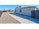 Side view of home showcasing a concrete walkway, gravel landscaping, and dark-trimmed windows at 457 Federal St, Henderson, NV 89015
