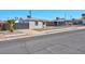 Charming single story home with gravel yard, covered porch, and convenient driveway access at 457 Federal St, Henderson, NV 89015