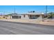Charming single story home with gravel yard, covered porch, and convenient driveway access at 457 Federal St, Henderson, NV 89015