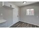 Galley style kitchen features white shaker cabinets, light countertops and new flooring at 457 Federal St, Henderson, NV 89015