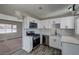 Updated kitchen features stainless appliances, white cabinets, and modern countertops at 457 Federal St, Henderson, NV 89015