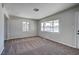 Bright living room featuring new carpeting and natural light from large windows at 457 Federal St, Henderson, NV 89015