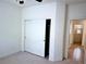 Bedroom with a closet and neutral carpet, next to a door leading to the bathroom at 4695 E Lucera Ct, Pahrump, NV 89061
