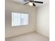 Simple bedroom featuring a large window for natural light and neutral carpet at 4695 E Lucera Ct, Pahrump, NV 89061