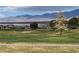 Scenic view of the golf course with lush green grass, set against a backdrop of mountains, offering a tranquil setting at 4695 E Lucera Ct, Pahrump, NV 89061