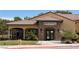 Charming grill room and bar building with a tile roof, stone accents, and outdoor seating, perfect for dining at 4695 E Lucera Ct, Pahrump, NV 89061